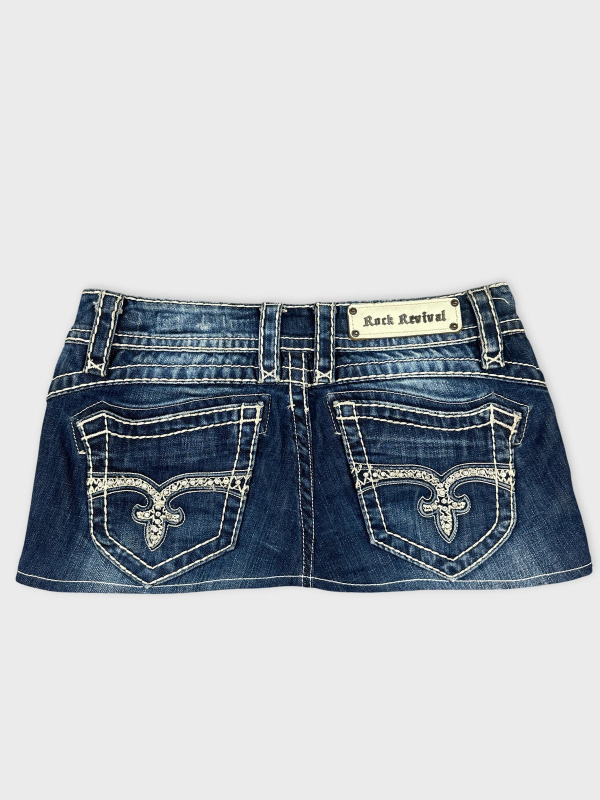 Back view of denim shorts in dark blue with embroidered pockets.
