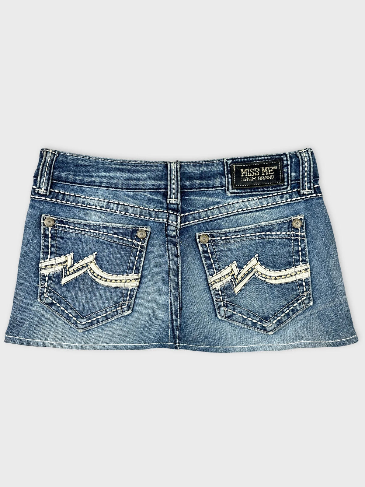 Back view of a blue denim skirt featuring decorative stitching on pockets.