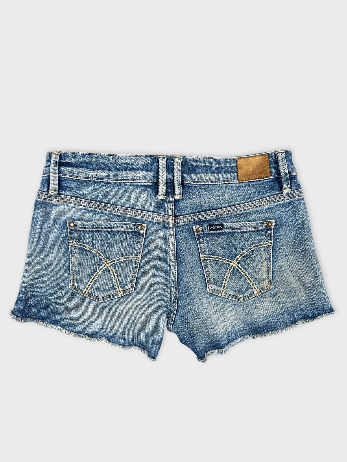 Back view of denim shorts in light blue with visible pockets and hem detail.