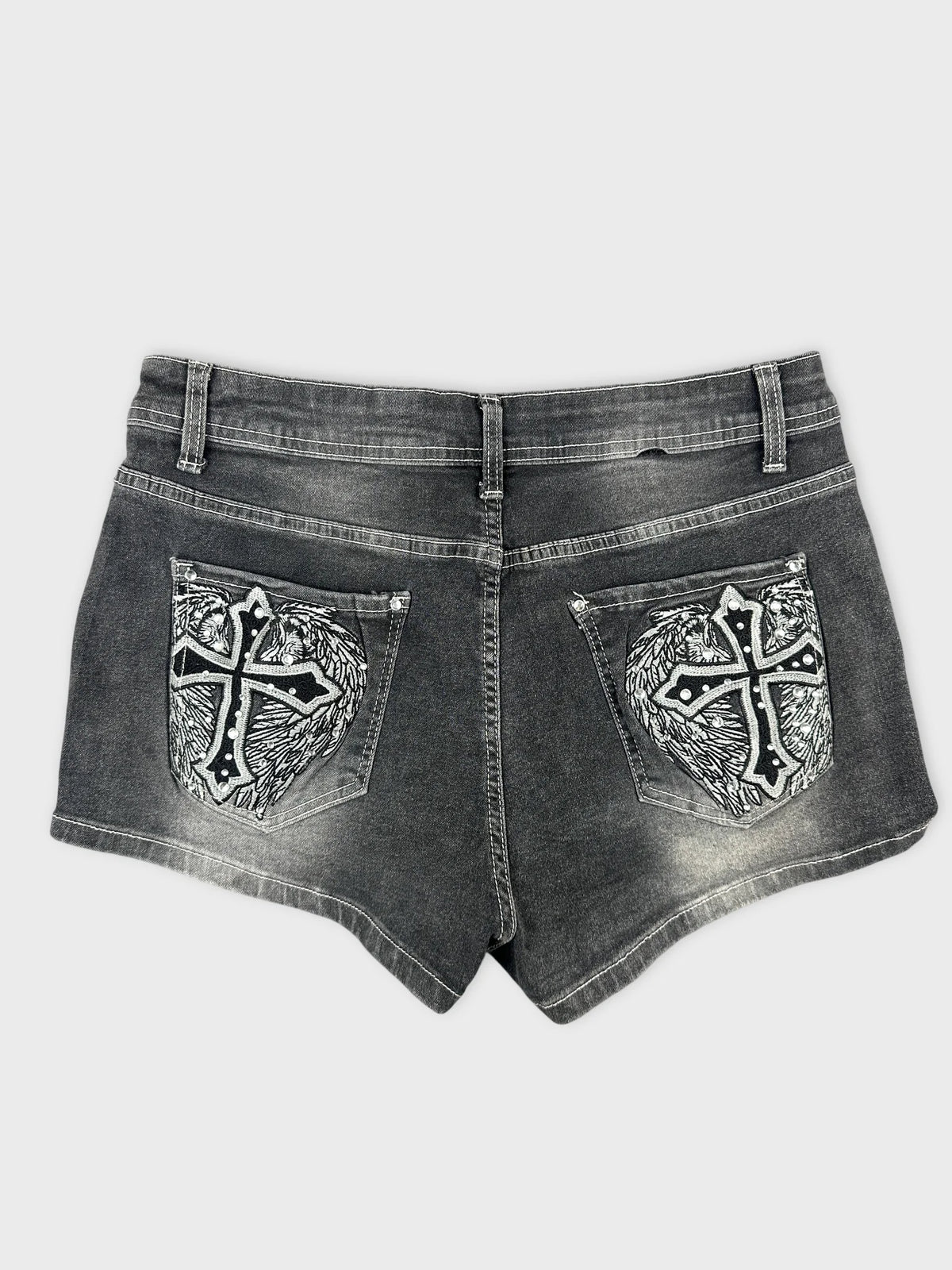 Back view of black denim shorts with embroidered cross design on pockets.