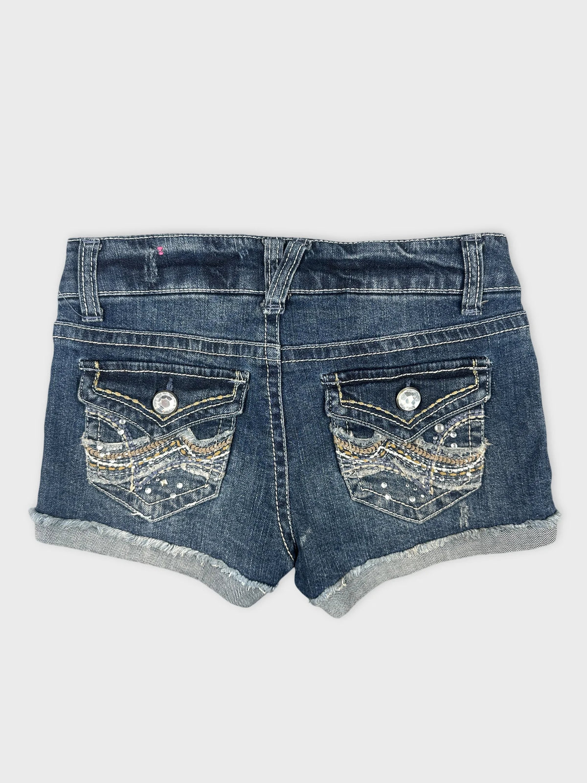 Back view of denim shorts featuring embellished back pockets and a dark wash.