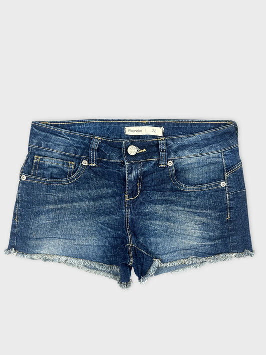 Front view of blue denim shorts with frayed hem and five pockets.