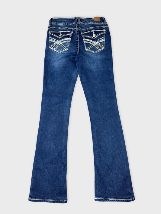 Back view of blue jeans featuring decorative pockets and stitching detail.