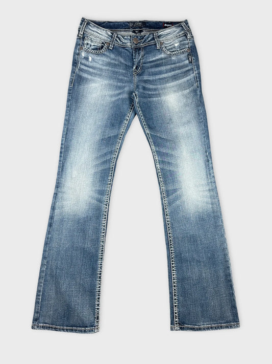 Front view of blue jeans featuring a faded wash and straight leg design.