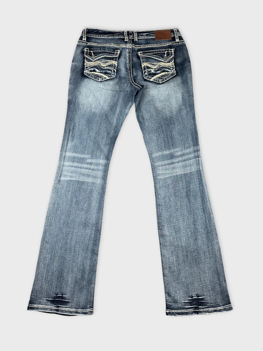 Back view of long blue jeans featuring detailed stitching on pockets