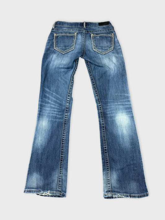 Back view of long blue jeans with subtle fading and two back pockets.