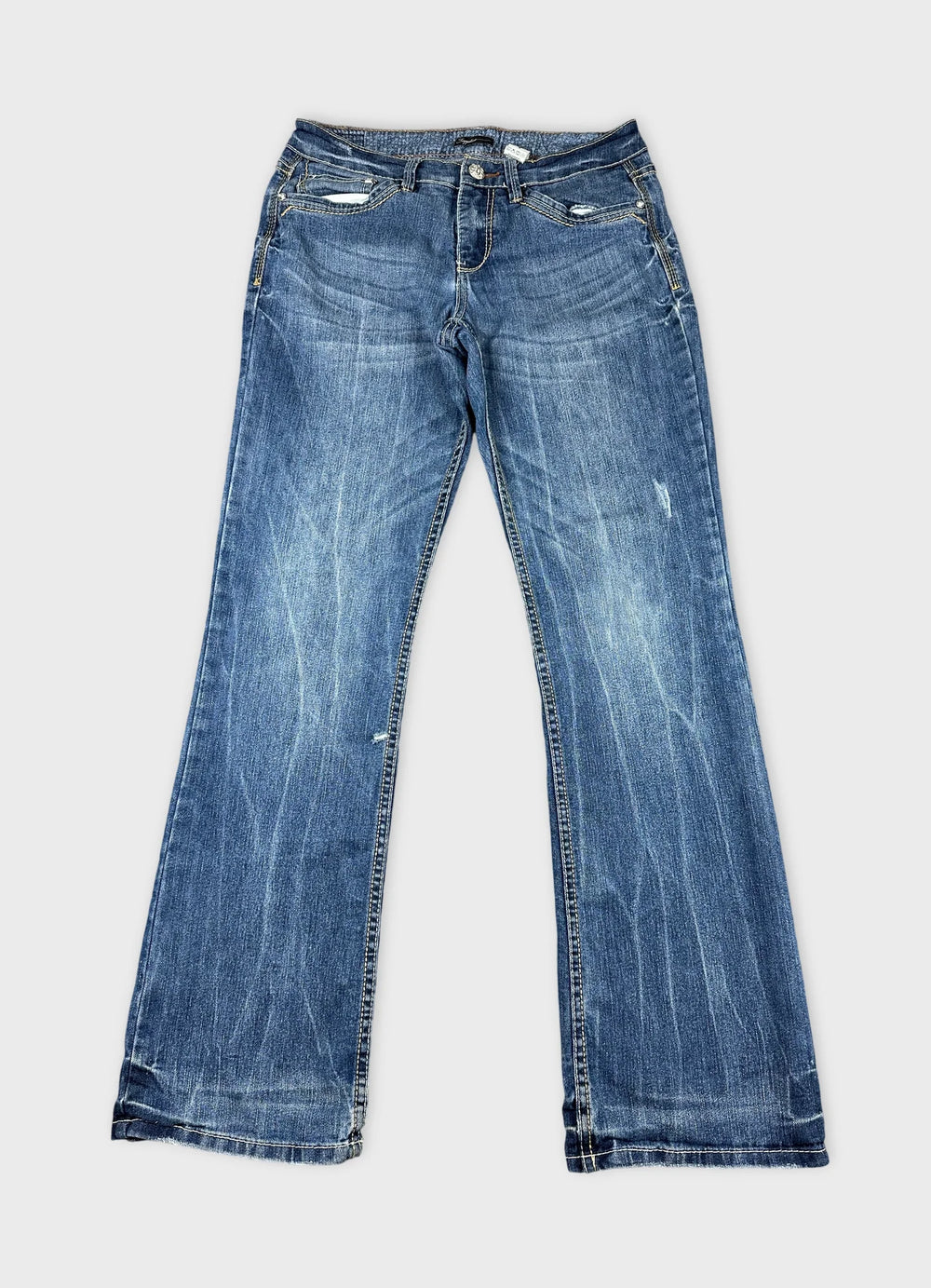 Front view of long blue jeans with slight distressed details.