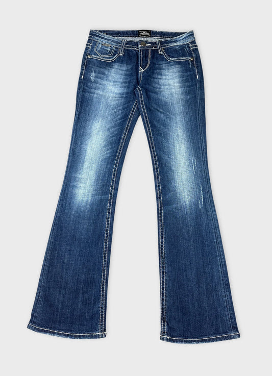 Front view of long blue jeans featuring distressed detailing and flared legs.