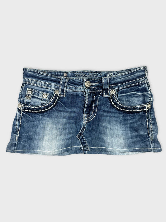 Front view of denim mini skirt featuring embellished pockets and white stitching.