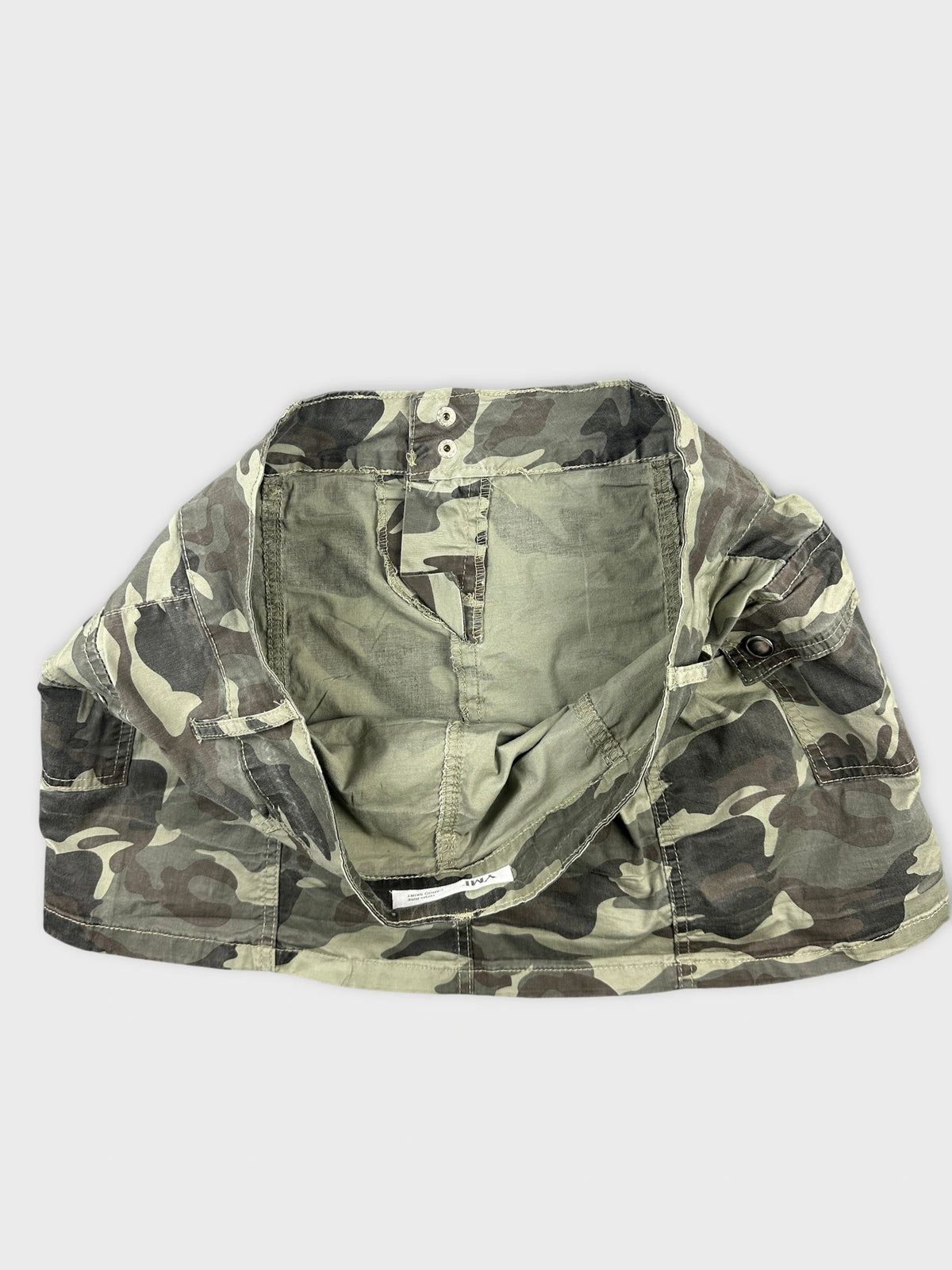 detail view of camouflaged shorts with a buttoned waistband