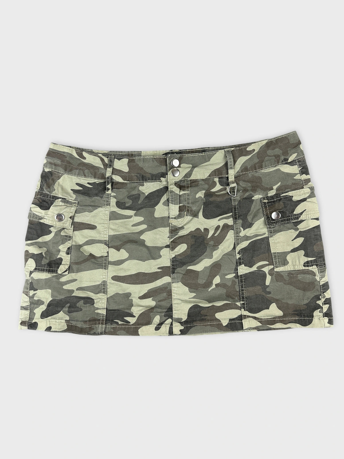 Front view of camo print mini skirt with pockets and two button details.