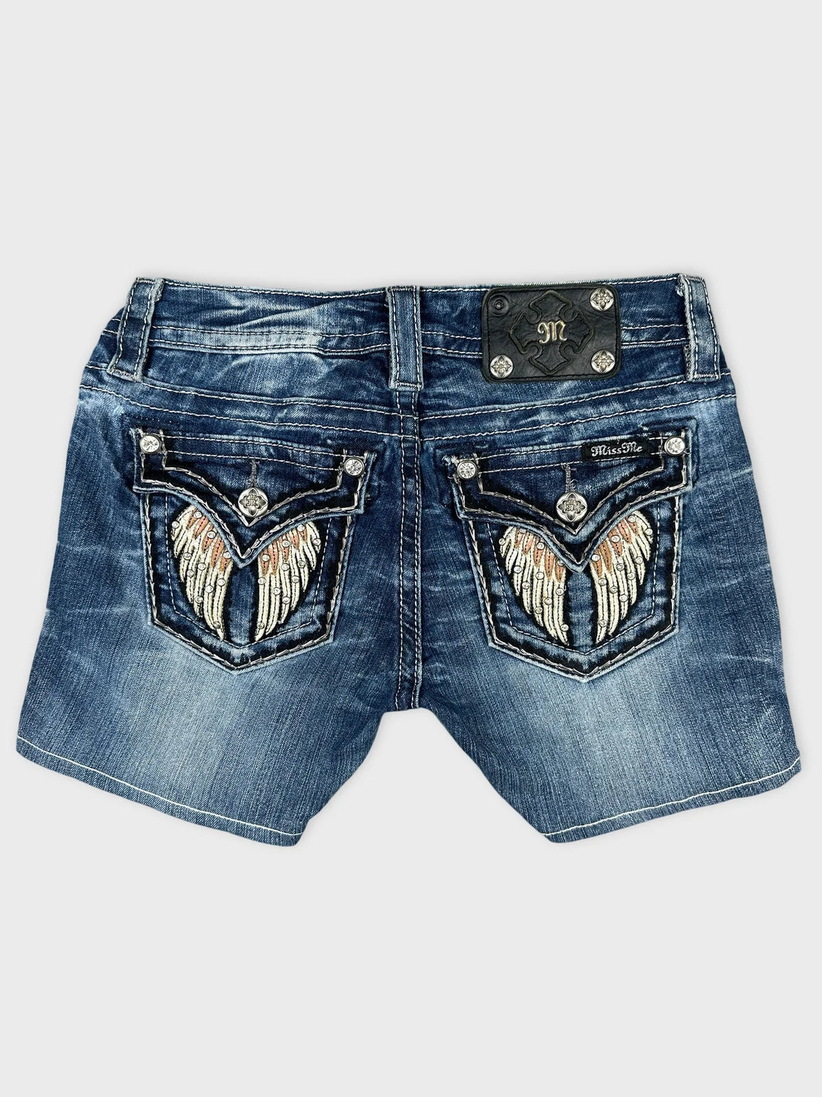 Back view of blue denim shorts featuring embroidered angel wings on pockets.