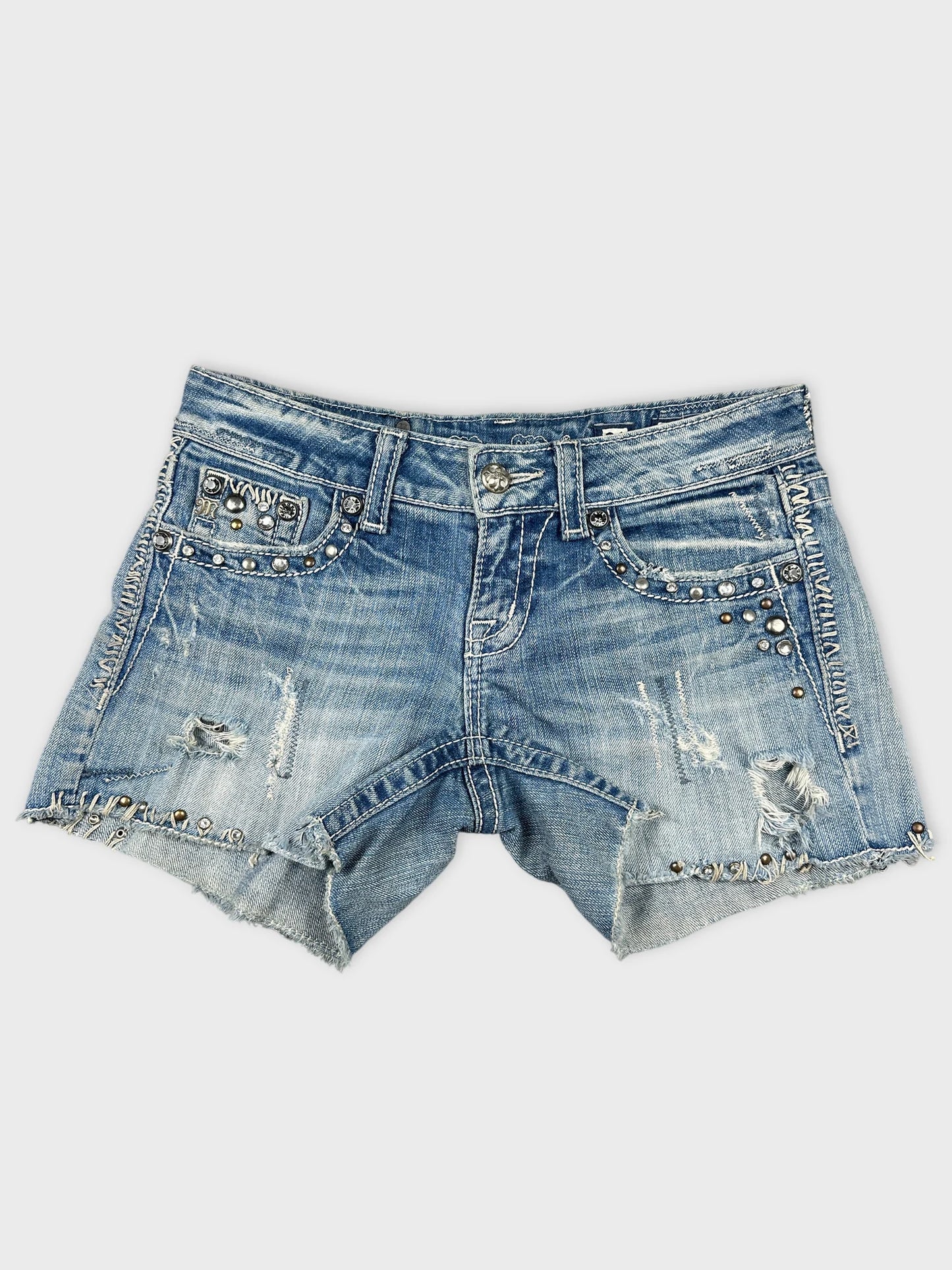 Front view of blue denim shorts with distressed detailing and stud embellishments.