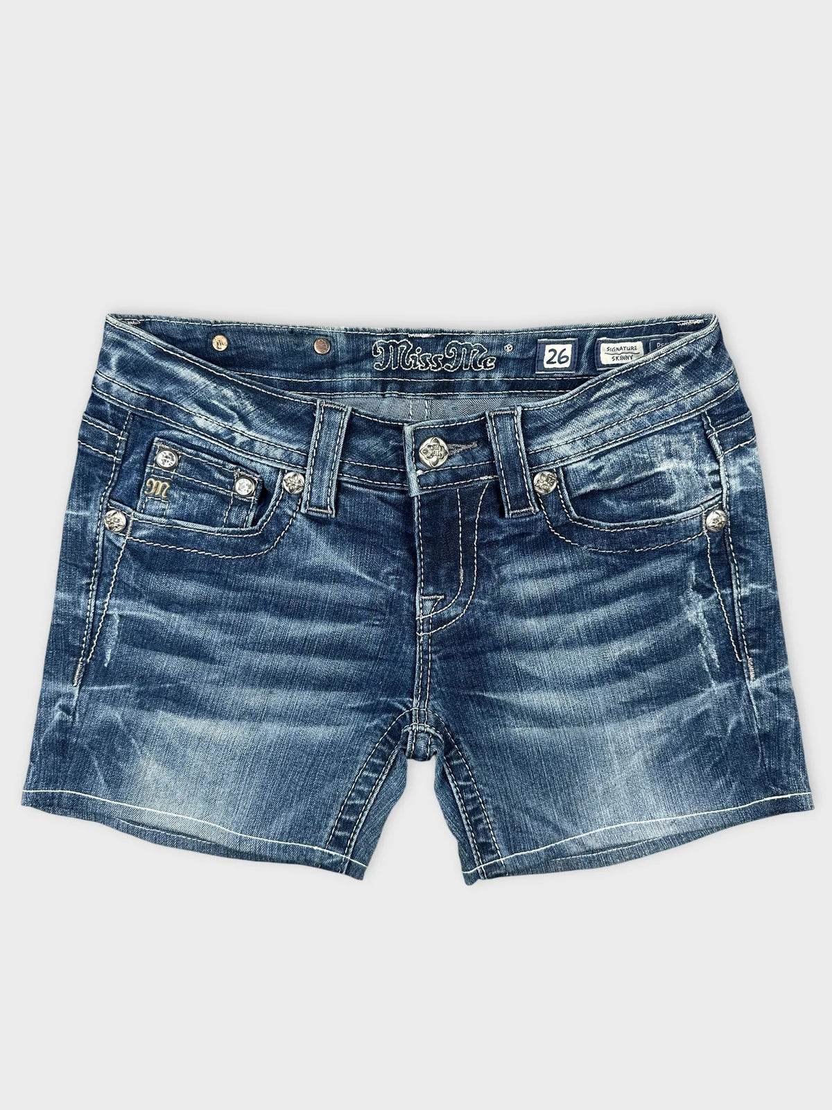 Front view of blue denim shorts featuring decorative stitching and distressed detailing.