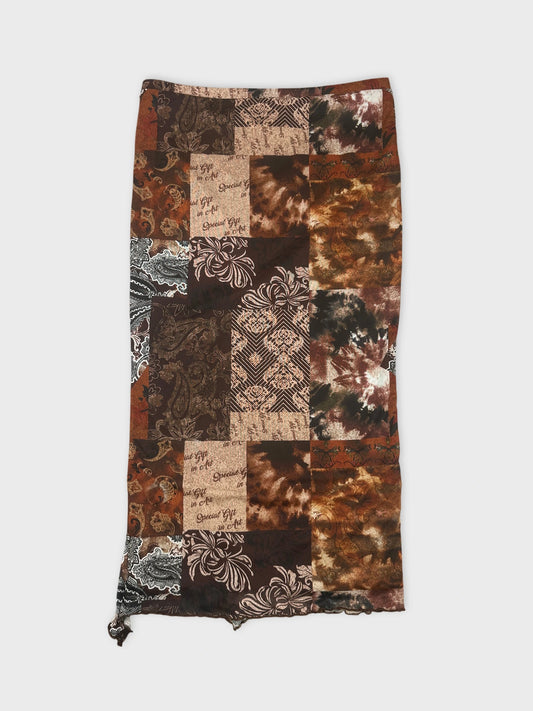 Back view of a patchwork skirt in brown tones with floral print.
