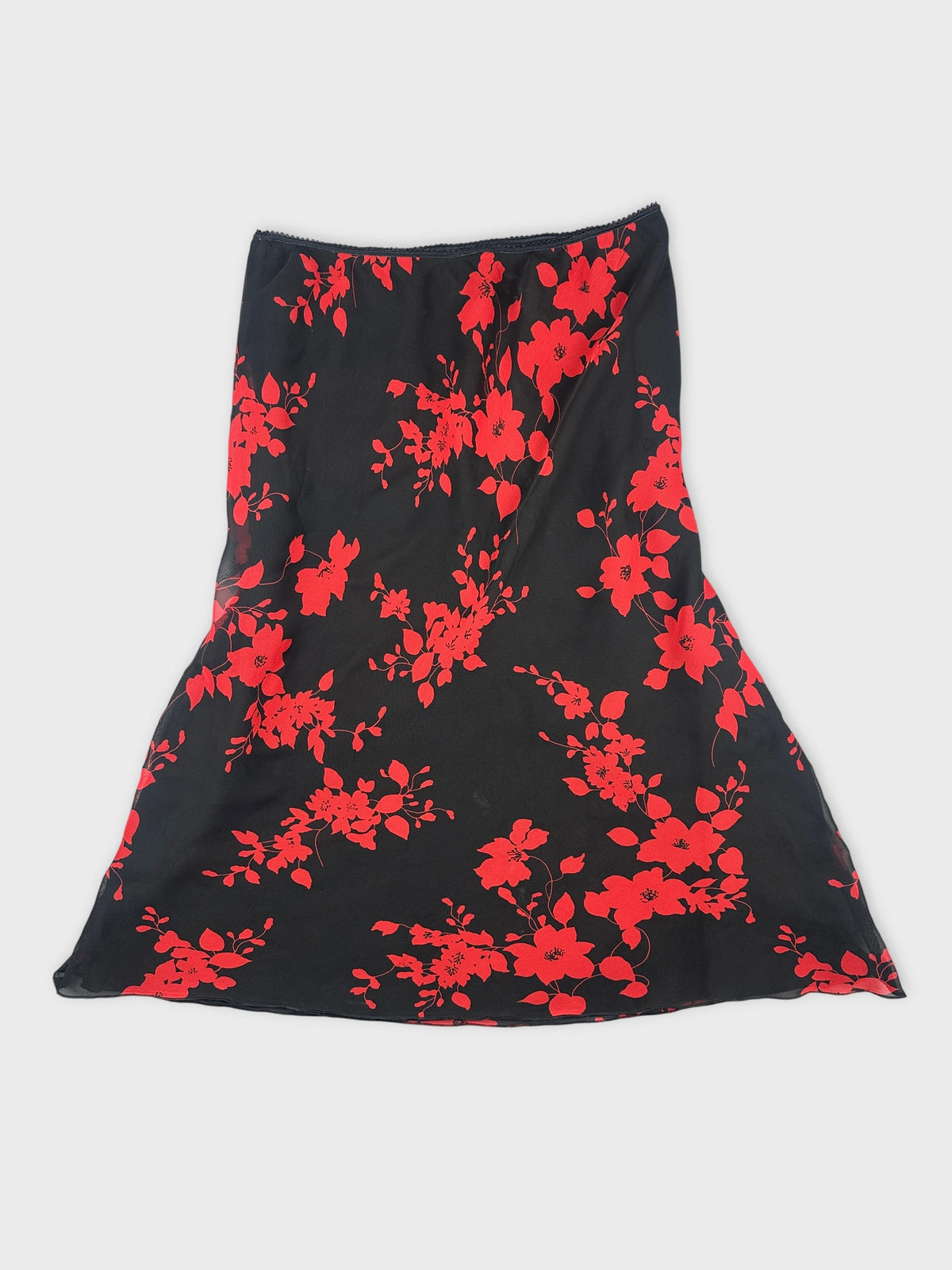 Back view of a black skirt with red floral pattern.