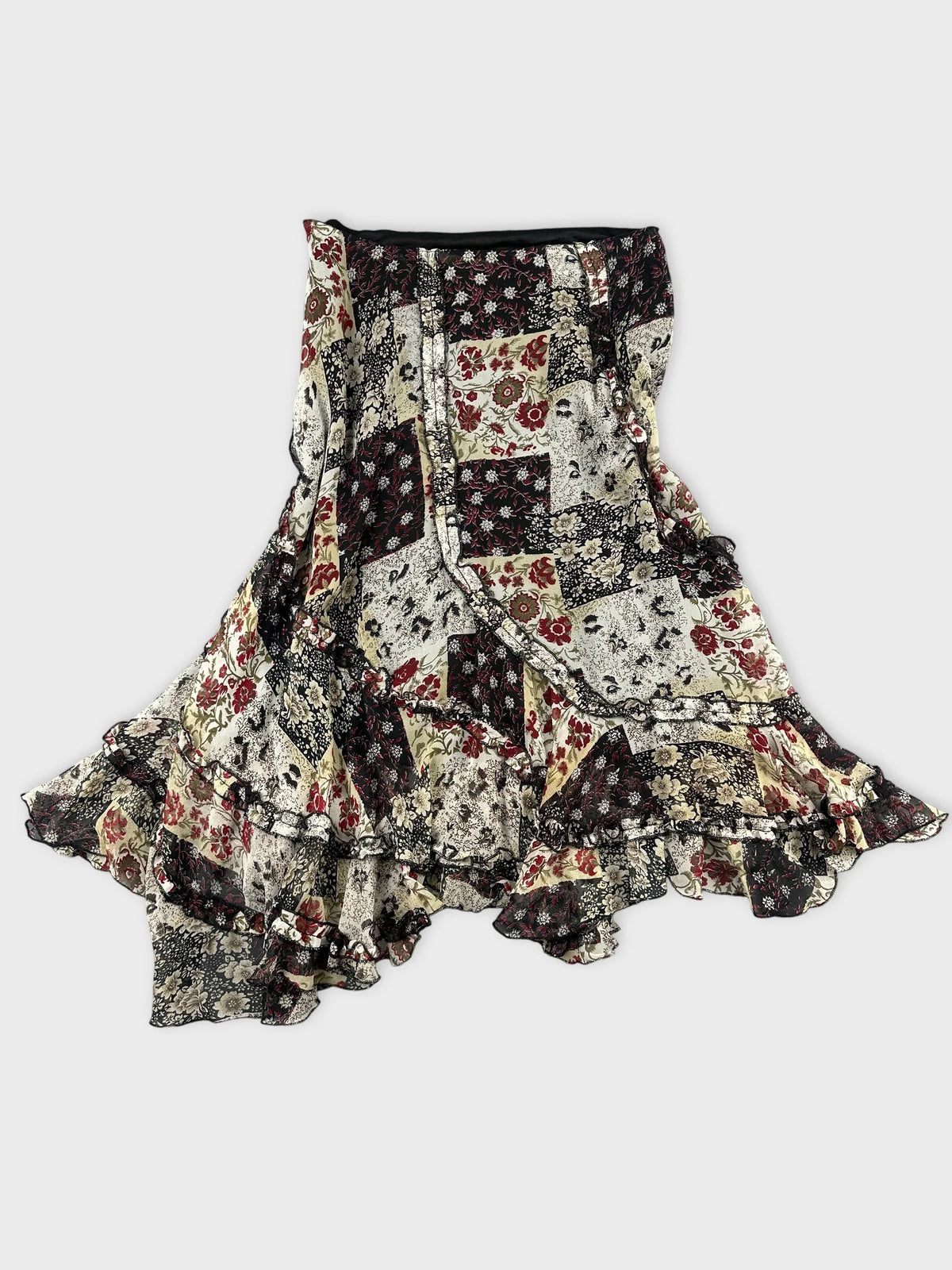 Back view of a floral vintage skirt in black and cream with ruffled trim.