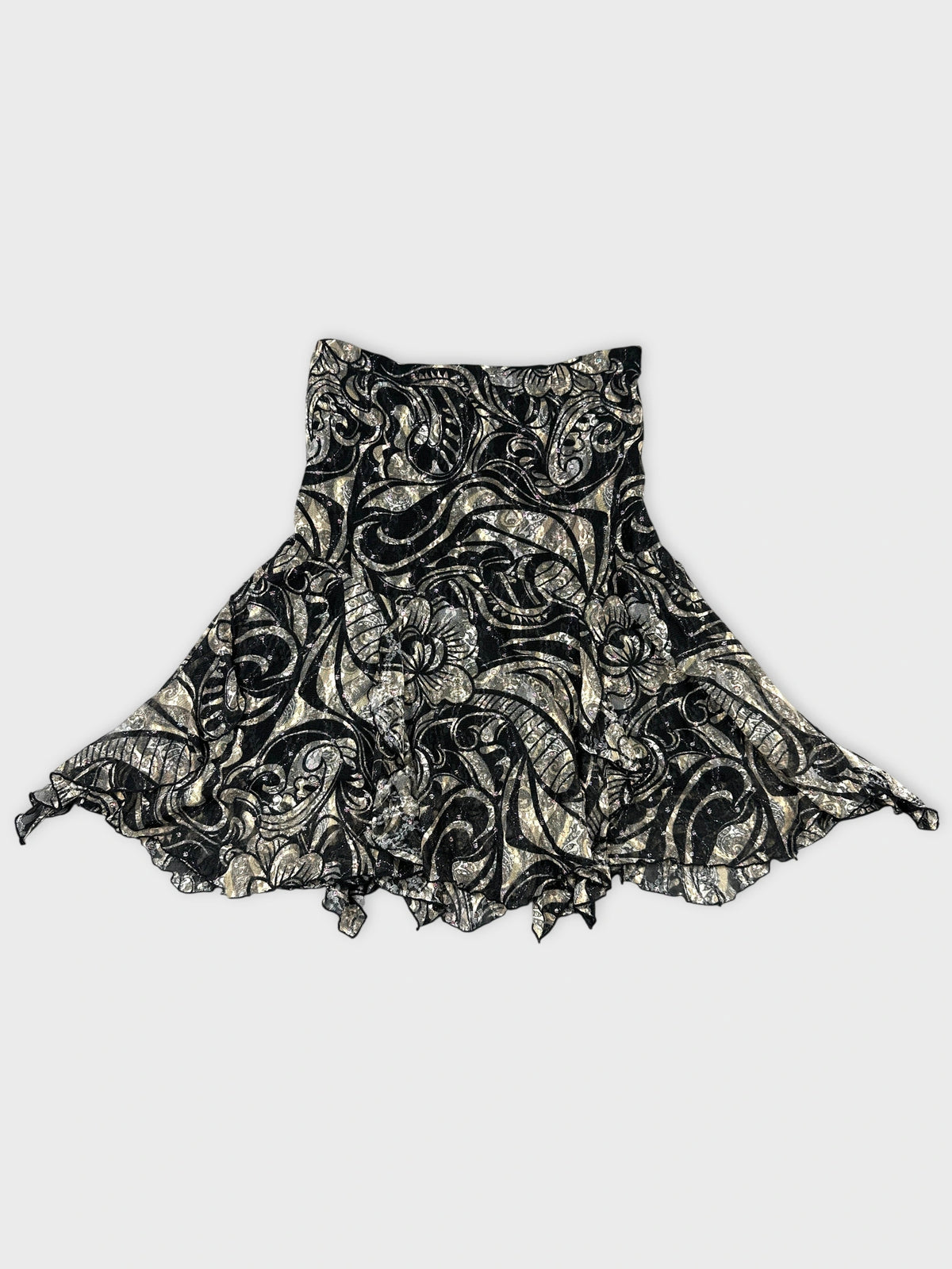 Back view of a black vintage skirt with floral pattern and ruffled hem.
