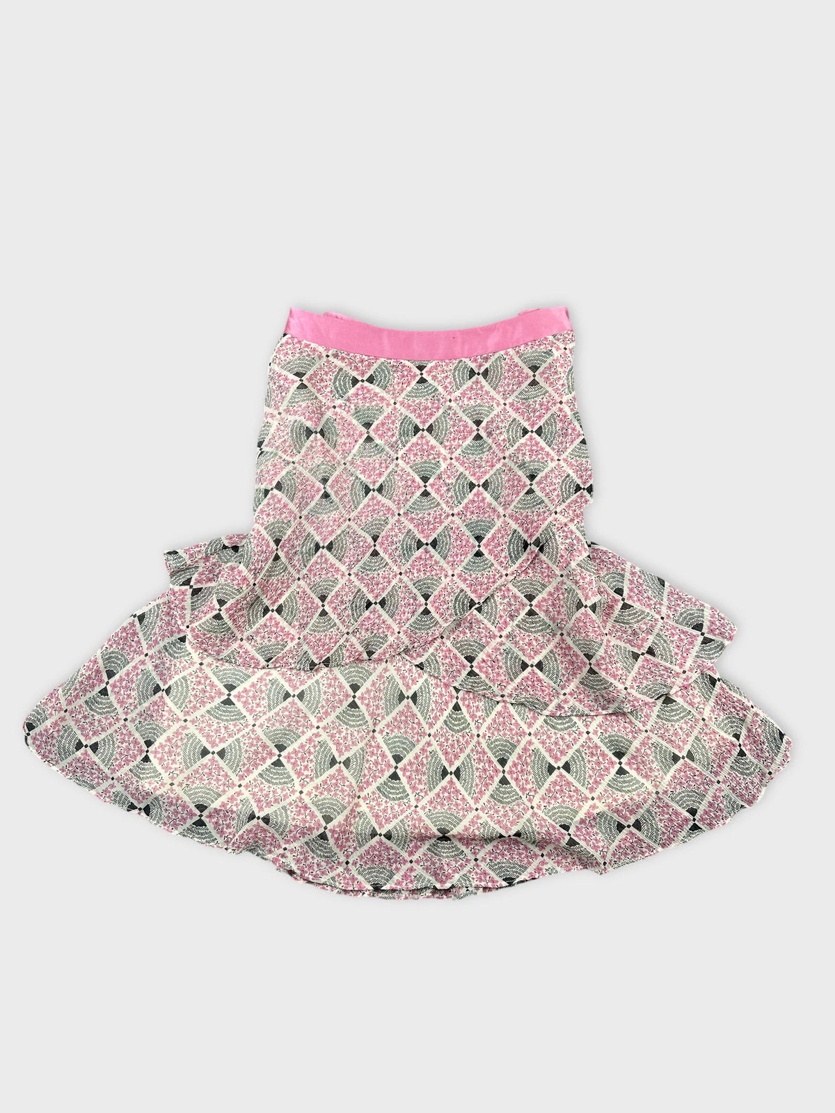 Back view of a skirt featuring a pink and black geometric pattern.
