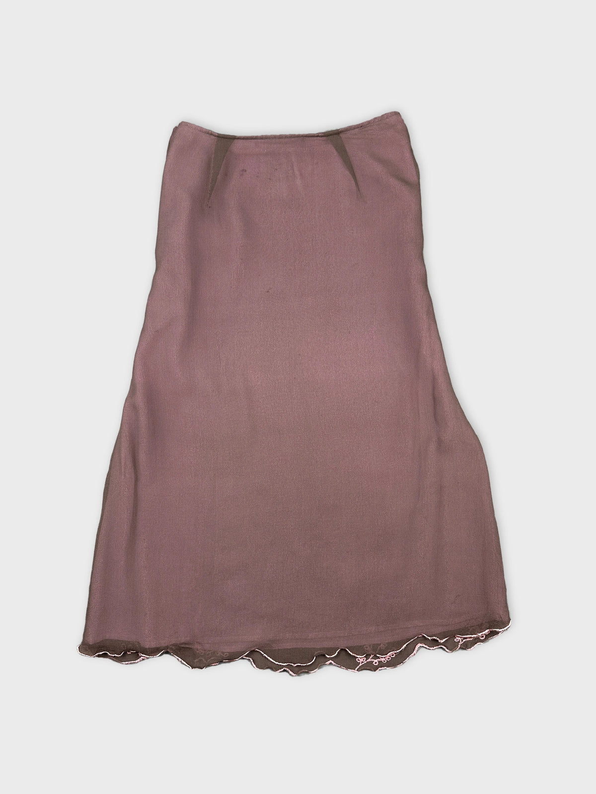 Back view of a vintage pink skirt with scalloped trim.