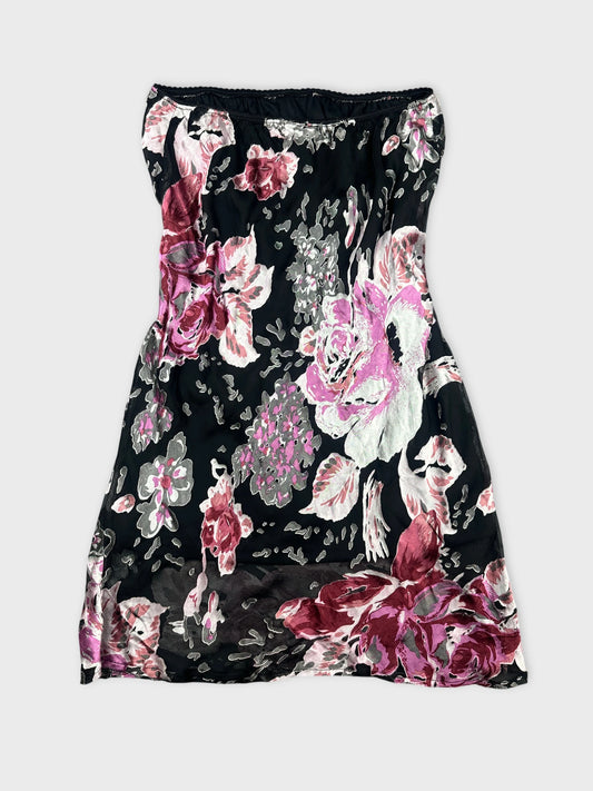 Back view of a black floral skirt with pink and white flowers.
