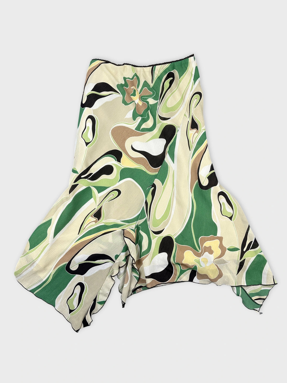 Back view of a green and beige patterned skirt with flowy shape.