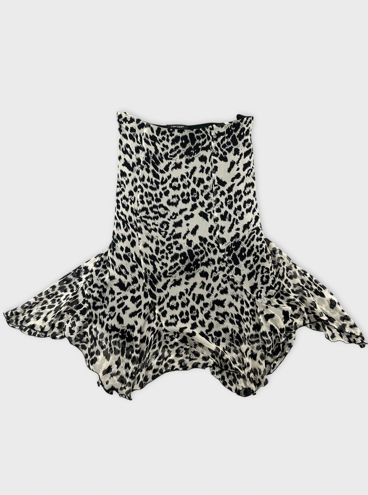 Back view of a black and white leopard print skirt with a flared hem.
