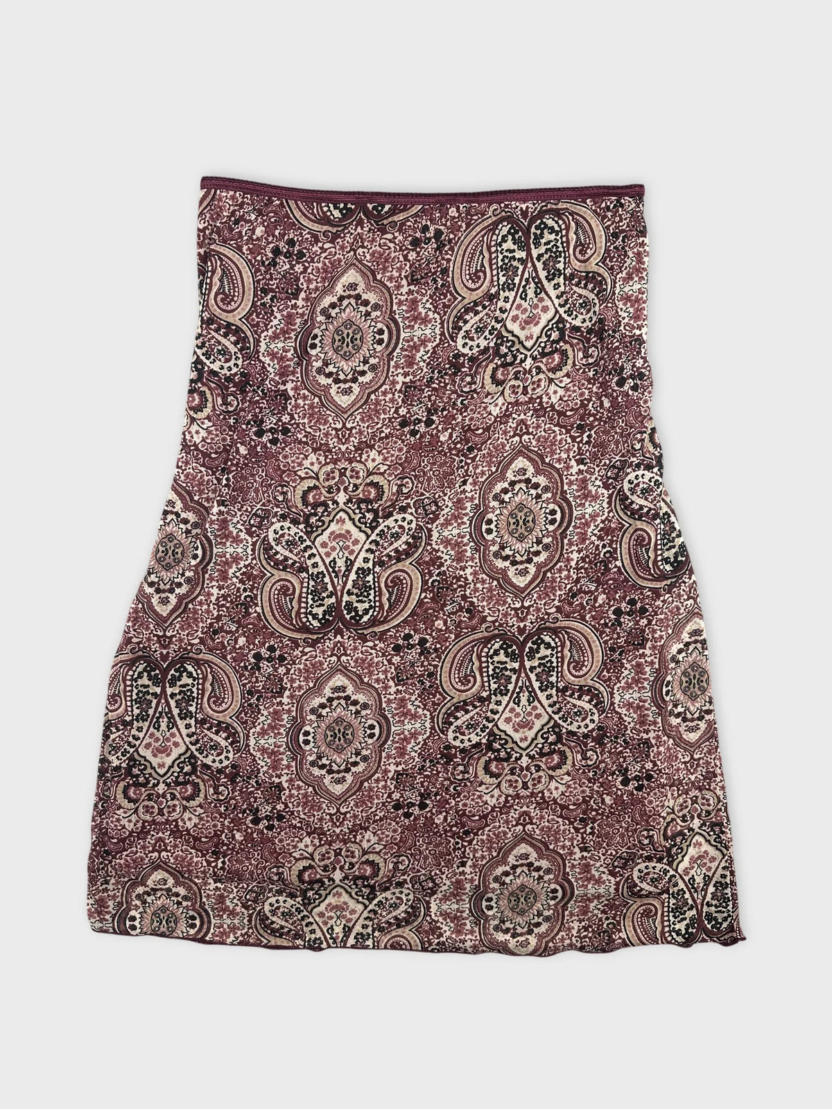 Back view of a burgundy printed skirt featuring an intricate paisley pattern.