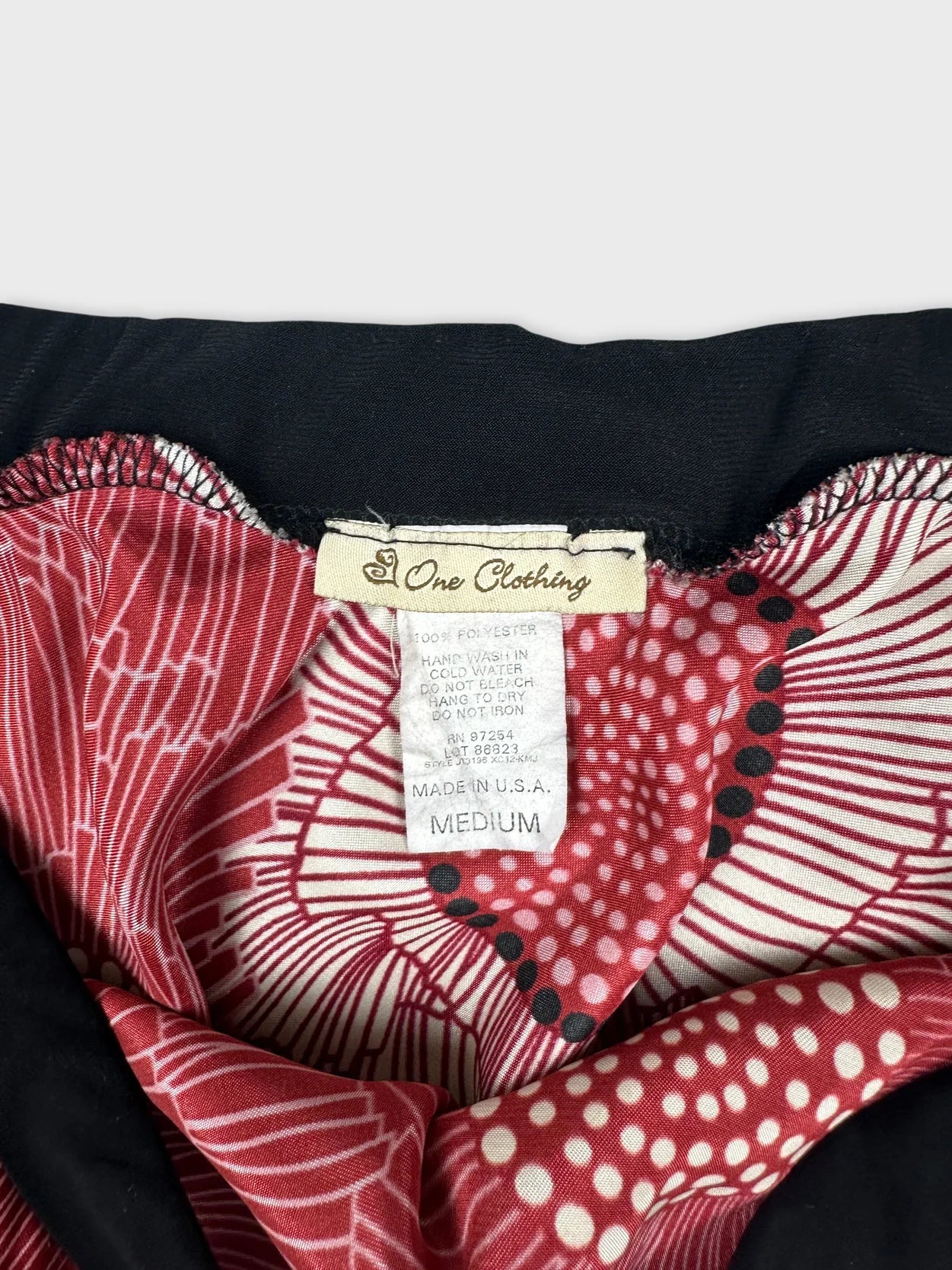 Detail view of a black and red patterned women's skirt.