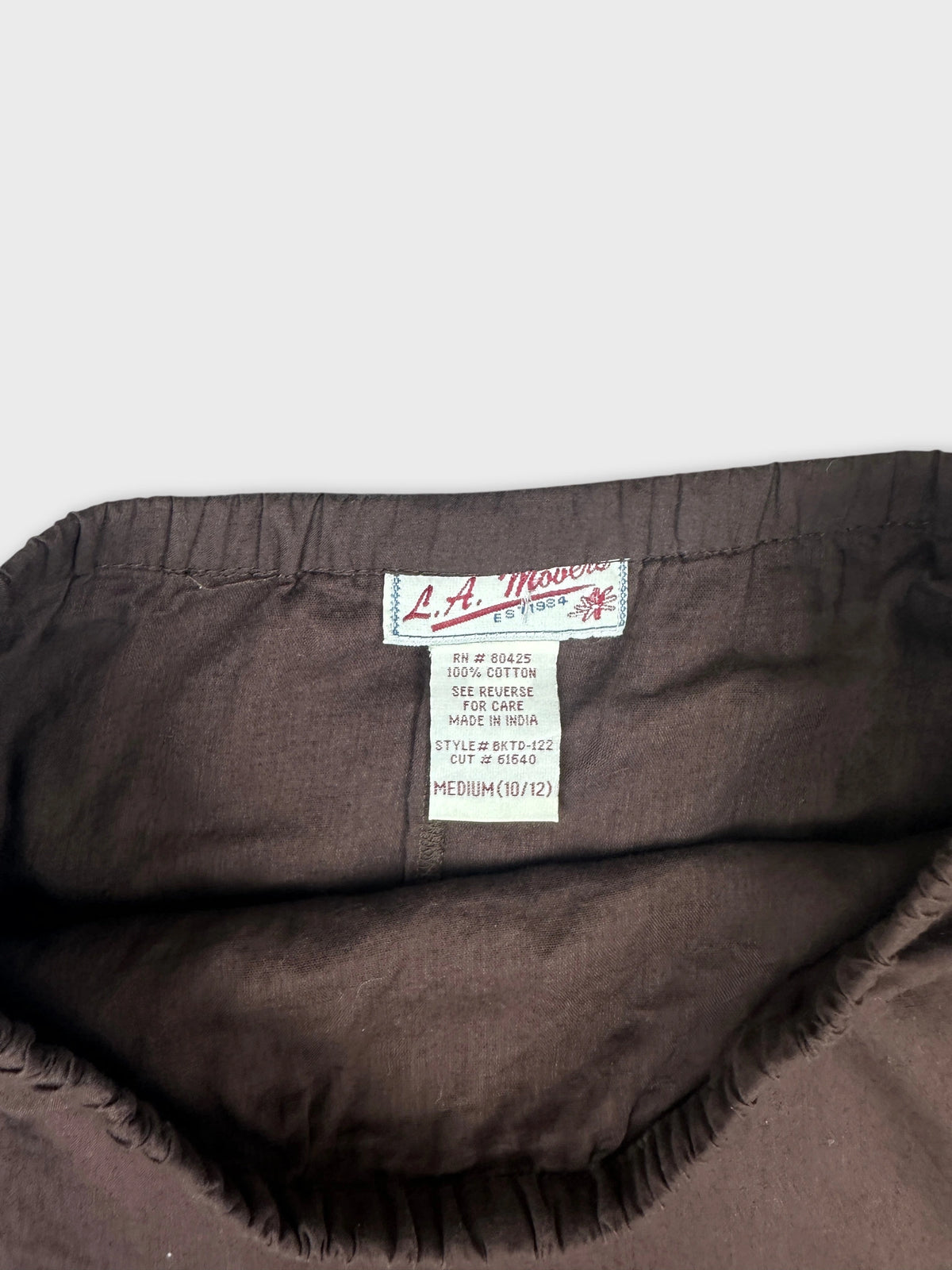 Detail view of brown vintage skirt with gathered waistband.