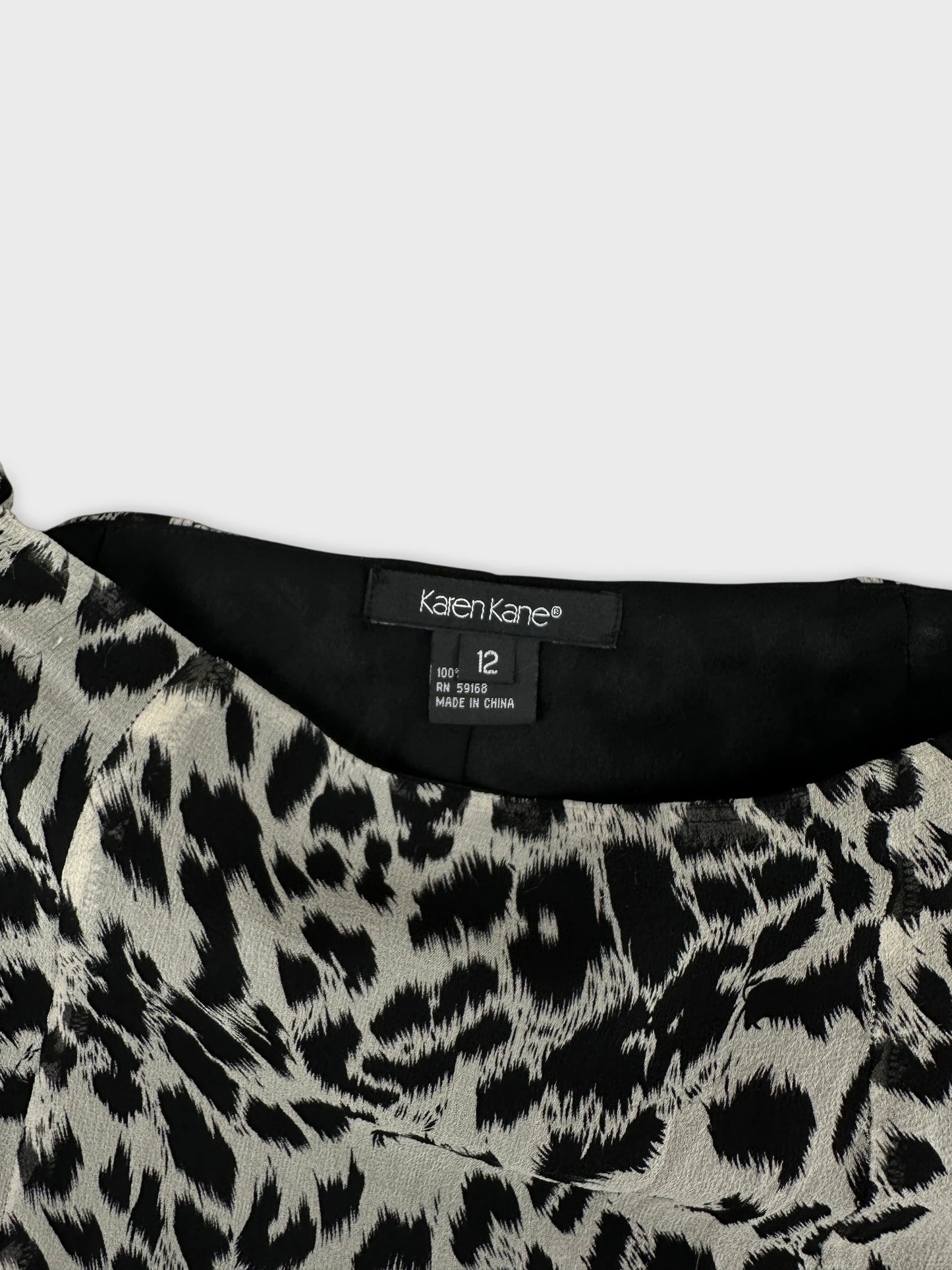 Detail view of a leopard print skirt in black and cream.