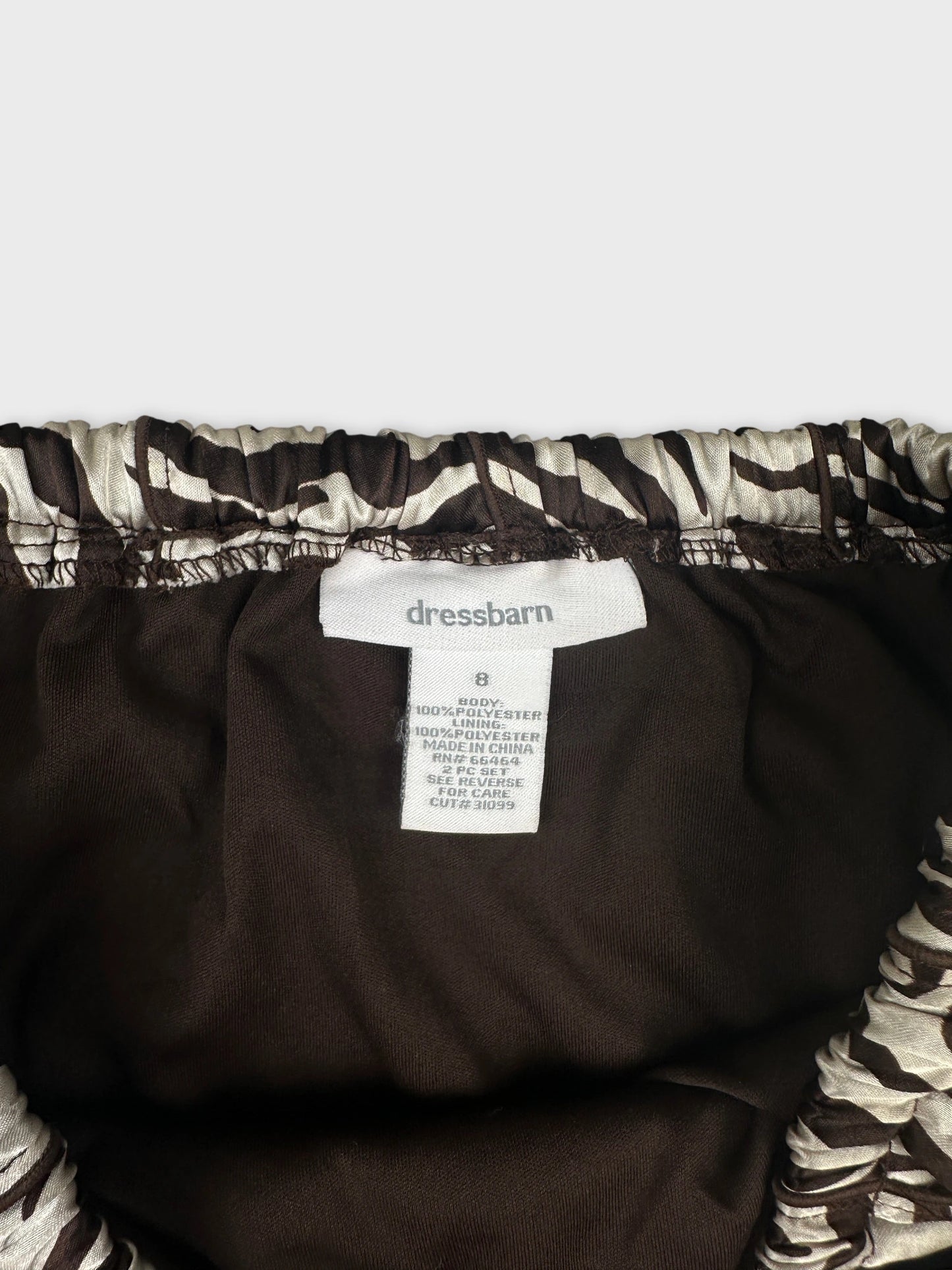 detail view of a brown skirt featuring a patterned waistband