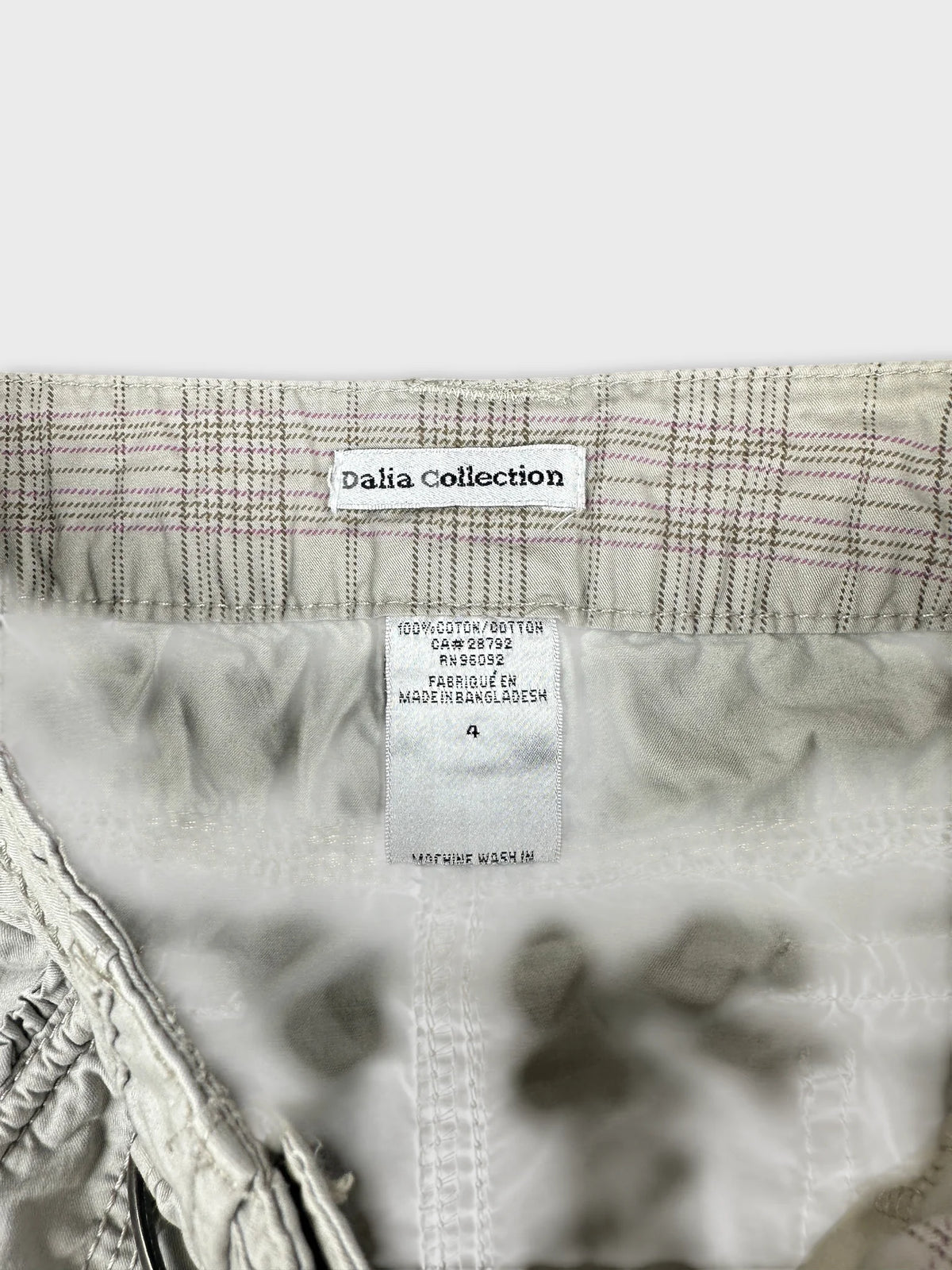 detail view of a light gray women's skirt with checked pattern