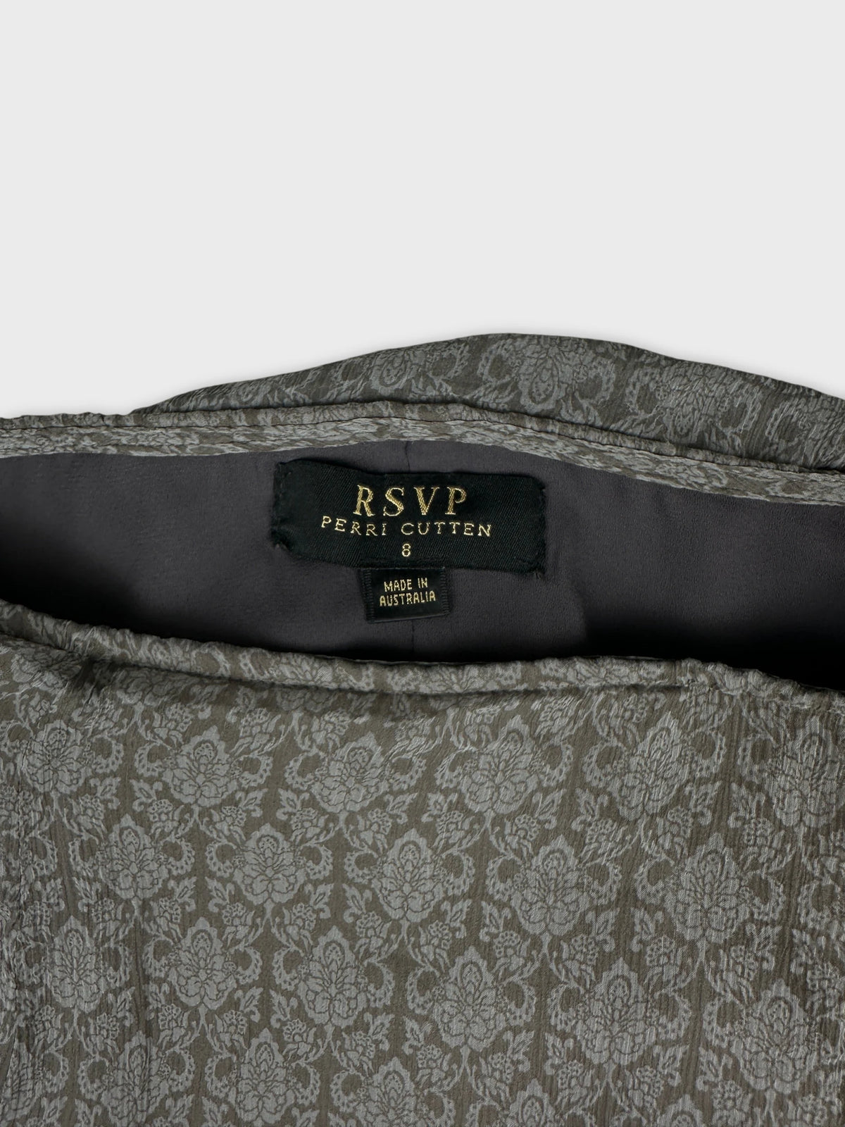 Detail view of a women's skirt featuring a floral print in grey.