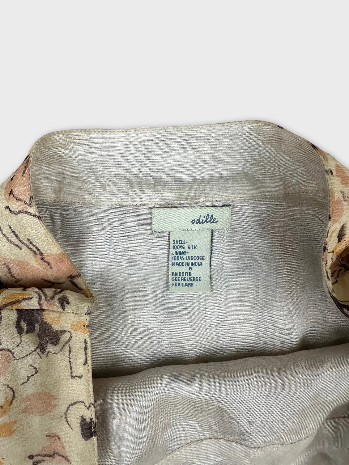 Detail view of women’s skirt with floral print and beige lining.