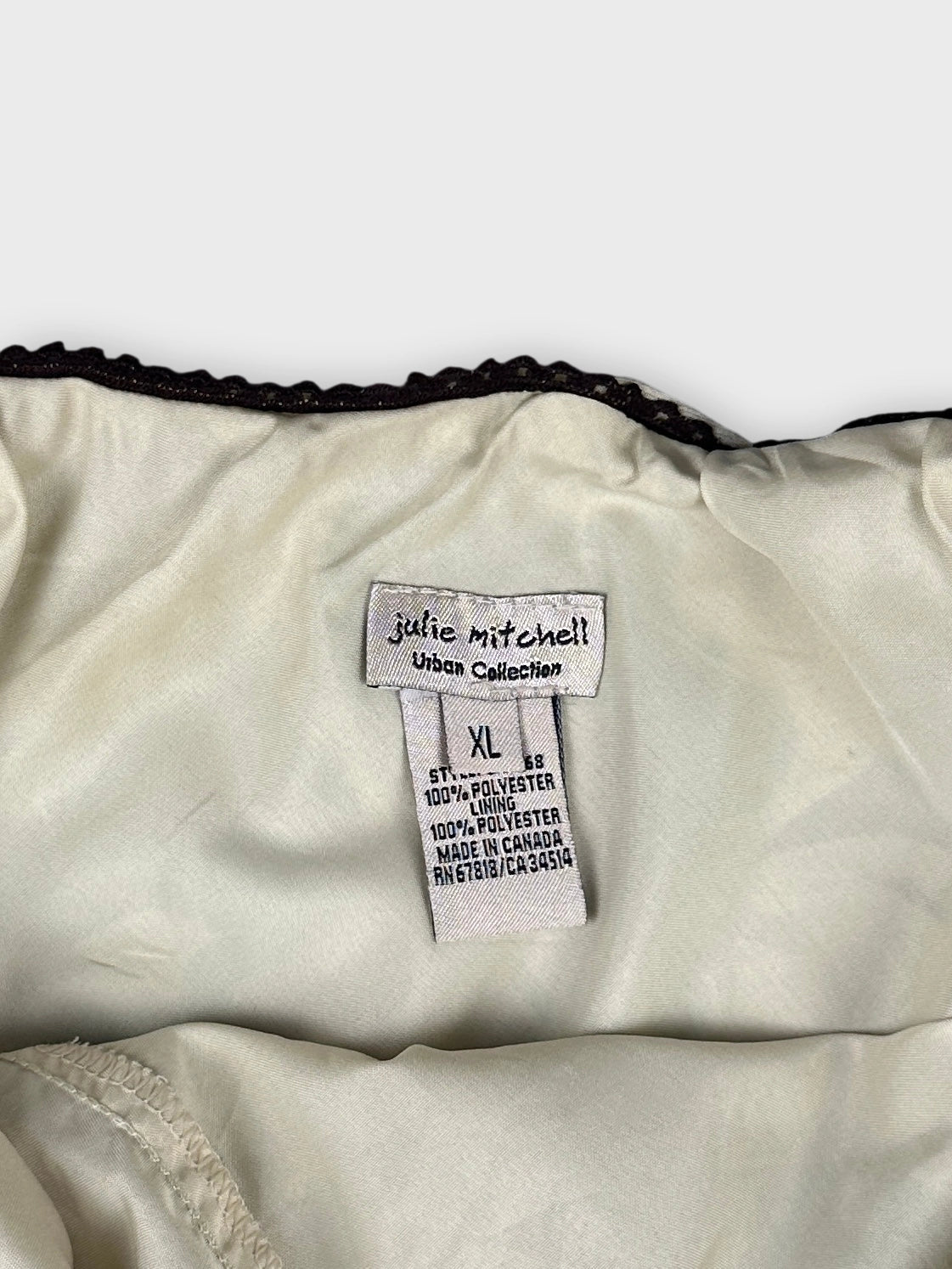 Detail view of vintage skirt with cream lining and black trim.