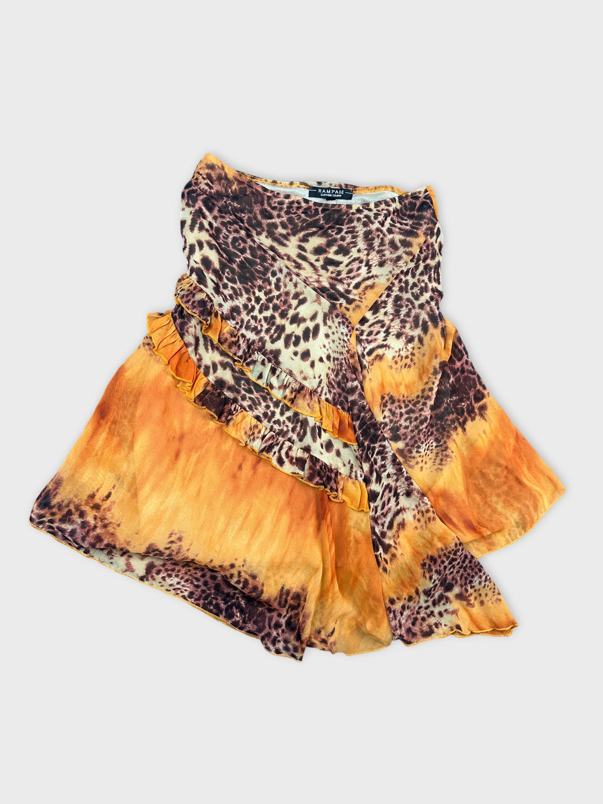 Detail view of a wrap skirt with orange and animal print pattern.