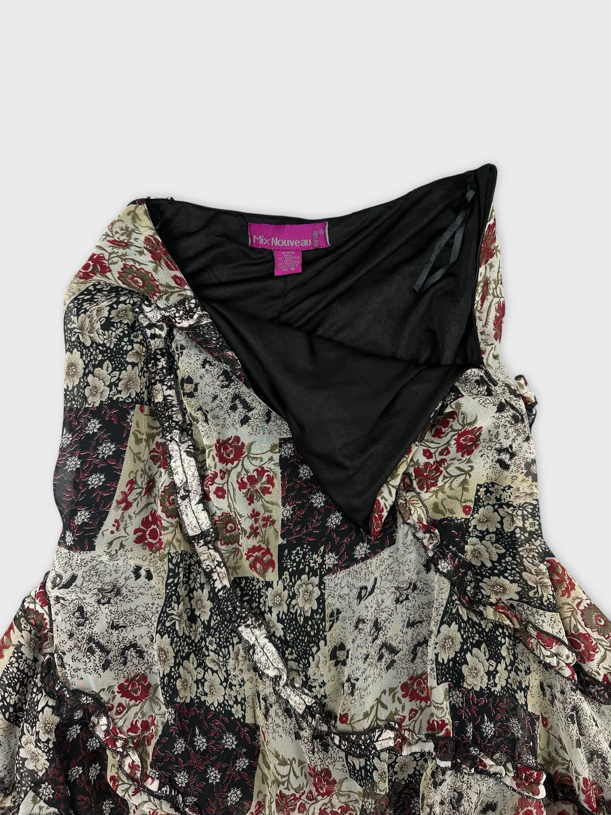 Detail view of a vintage skirt with floral patterns in red and black.