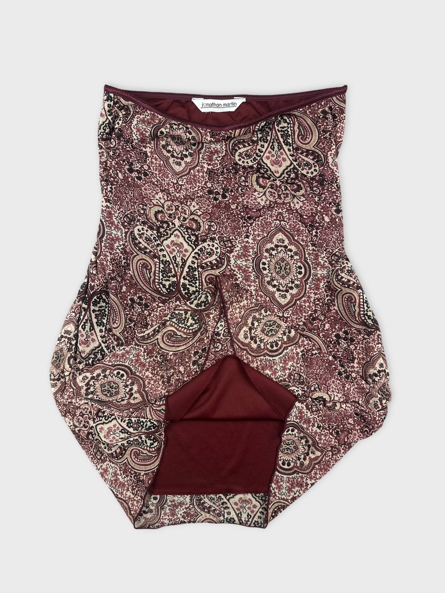 Detail view of a maroon paisley print women's bottom skirt.
