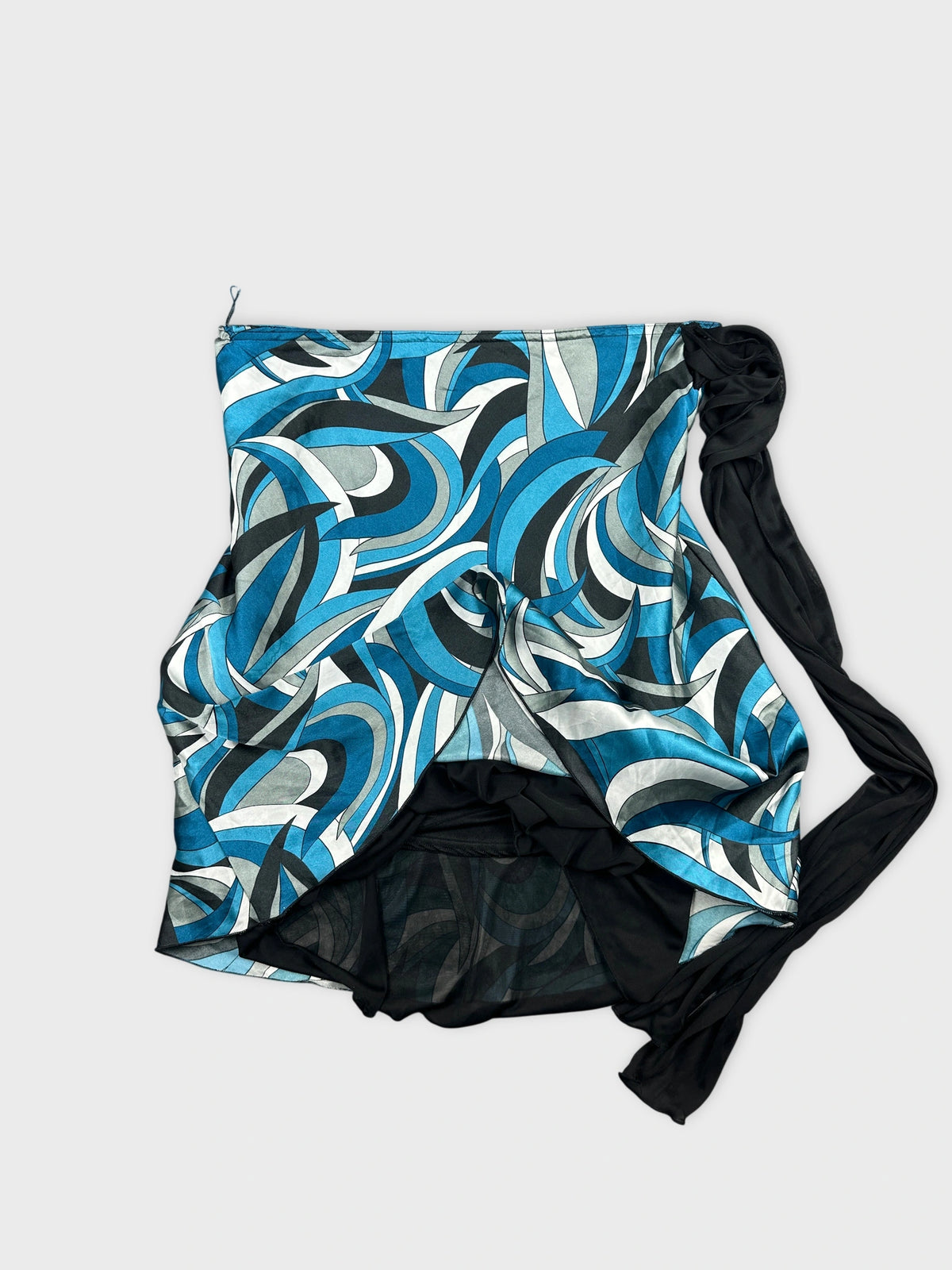 Detail view of a women's vintage skirt in blue swirling print with black trim.