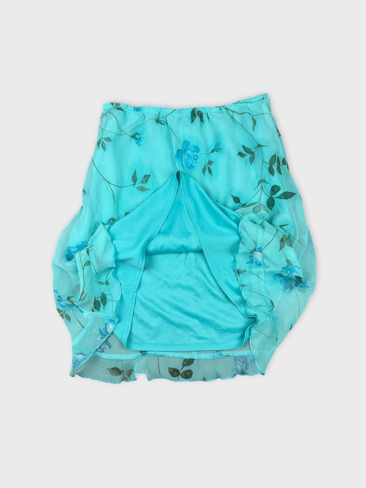 Floral print turquoise skirt detail view with ruffled trim and inner lining