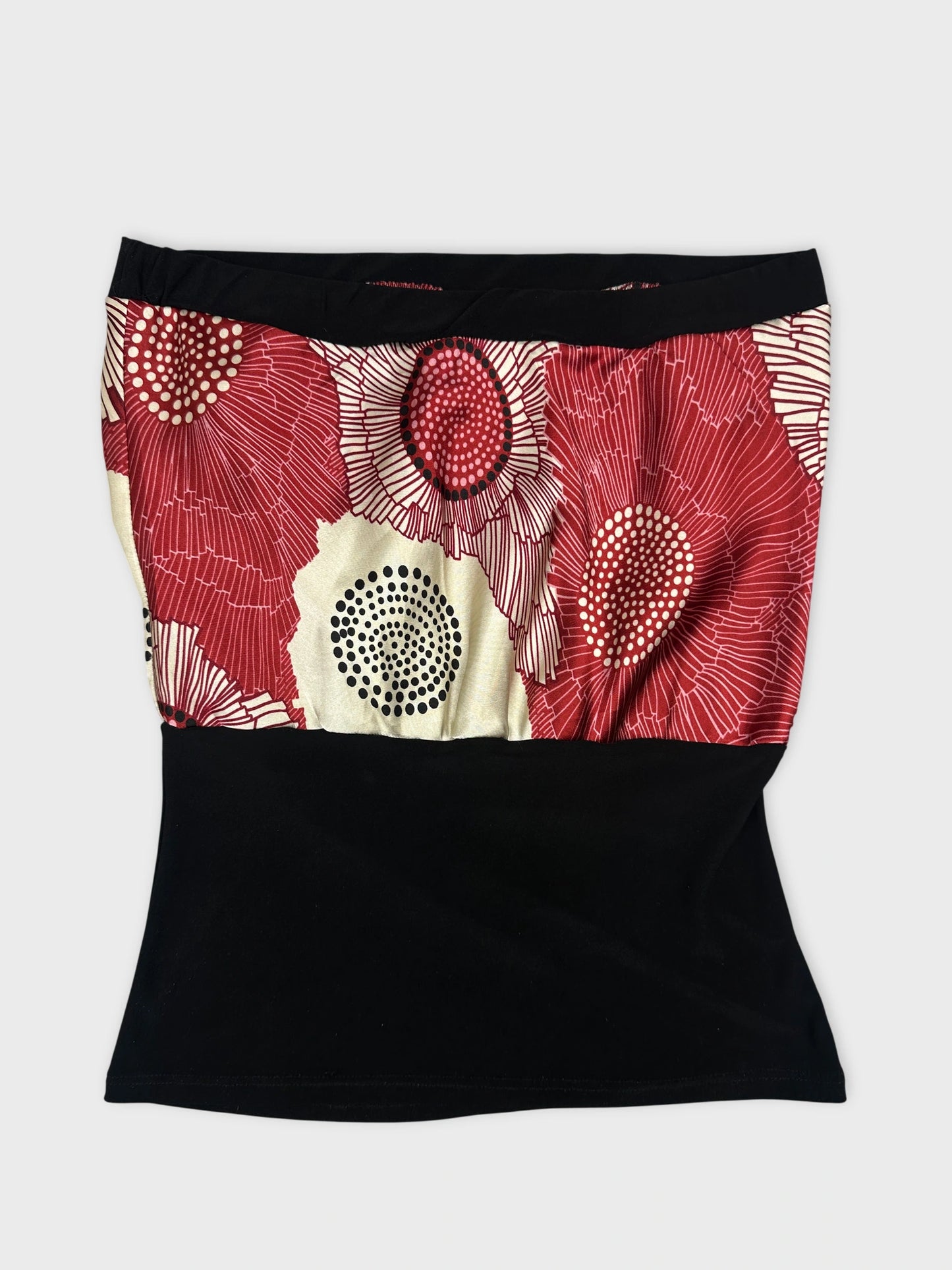 Front view of a vintage skirt with a red floral pattern and black bottom.