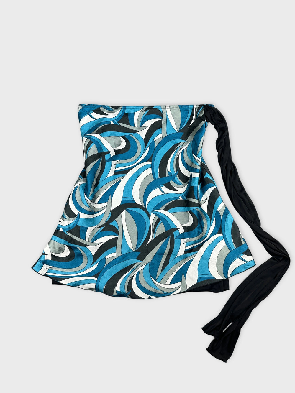 Front view of a blue patterned skirt featuring wave-like designs and a black tie.