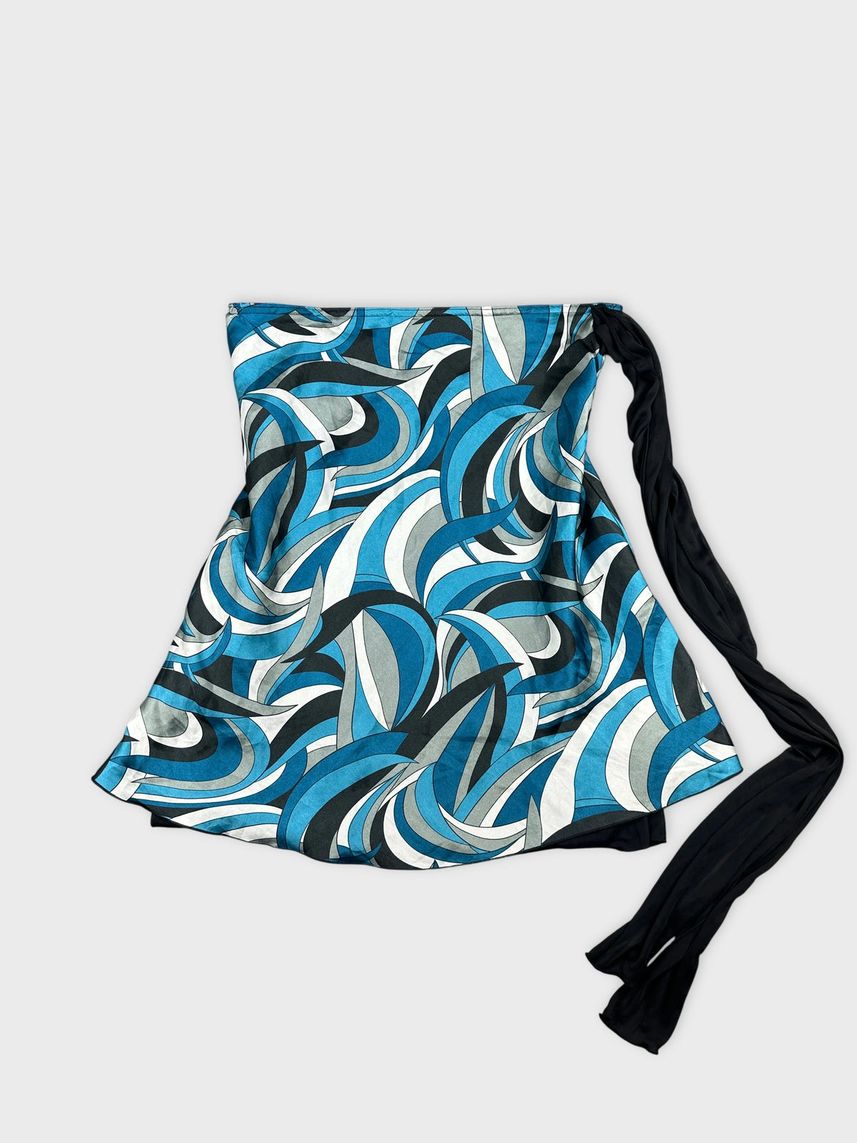 Front view of a blue patterned skirt featuring wave-like designs and a black tie.