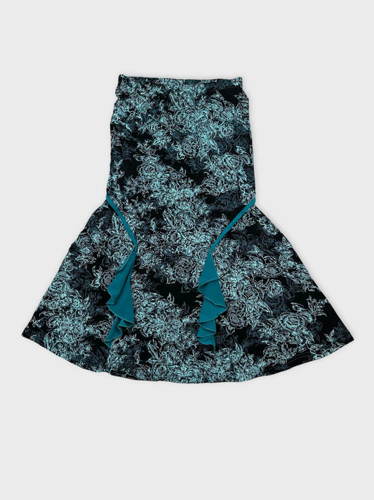 Front view of a black floral skirt with frill details.
