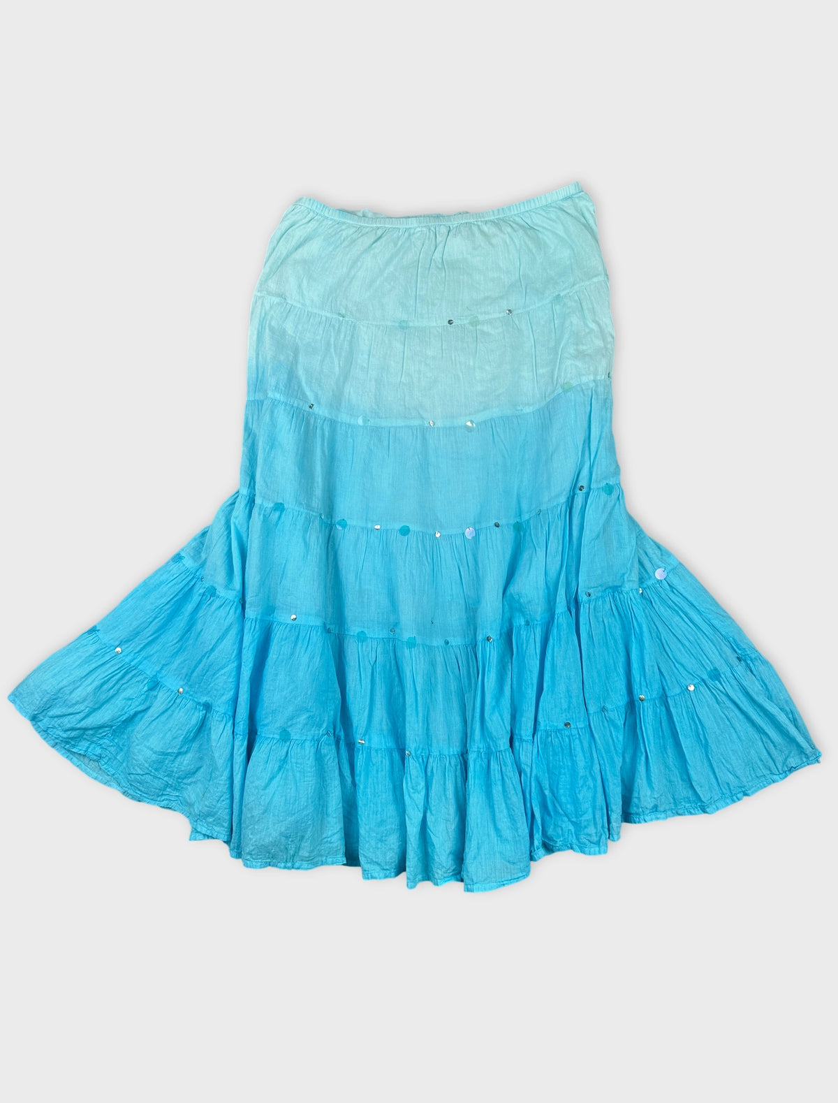 Front view of a tiered blue skirt with decorative buttons.