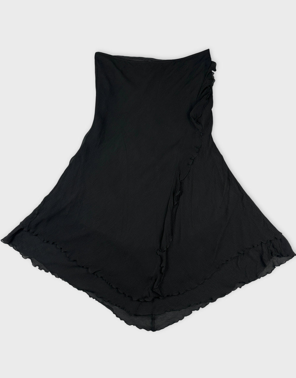 Black skirt with ruffled hem shown in front view.