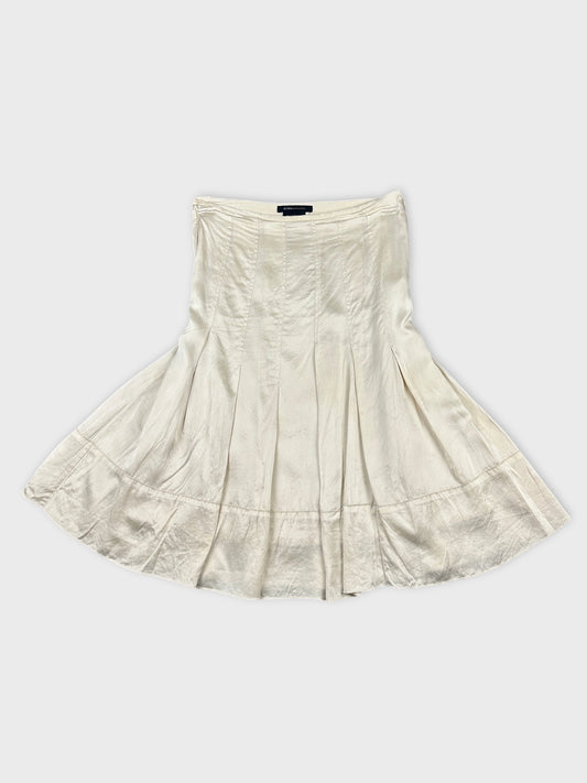 A white skirt with a flared hem shown in front view.