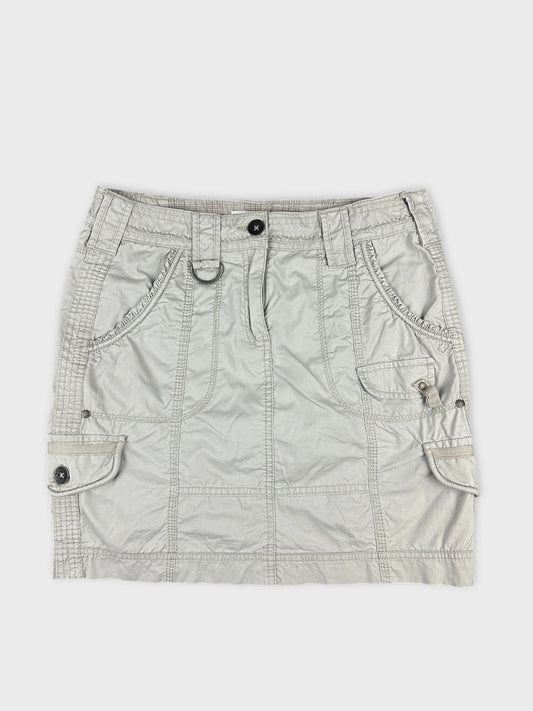 Front view of a silver women’s skirt featuring buttoned pockets and textured fabric.