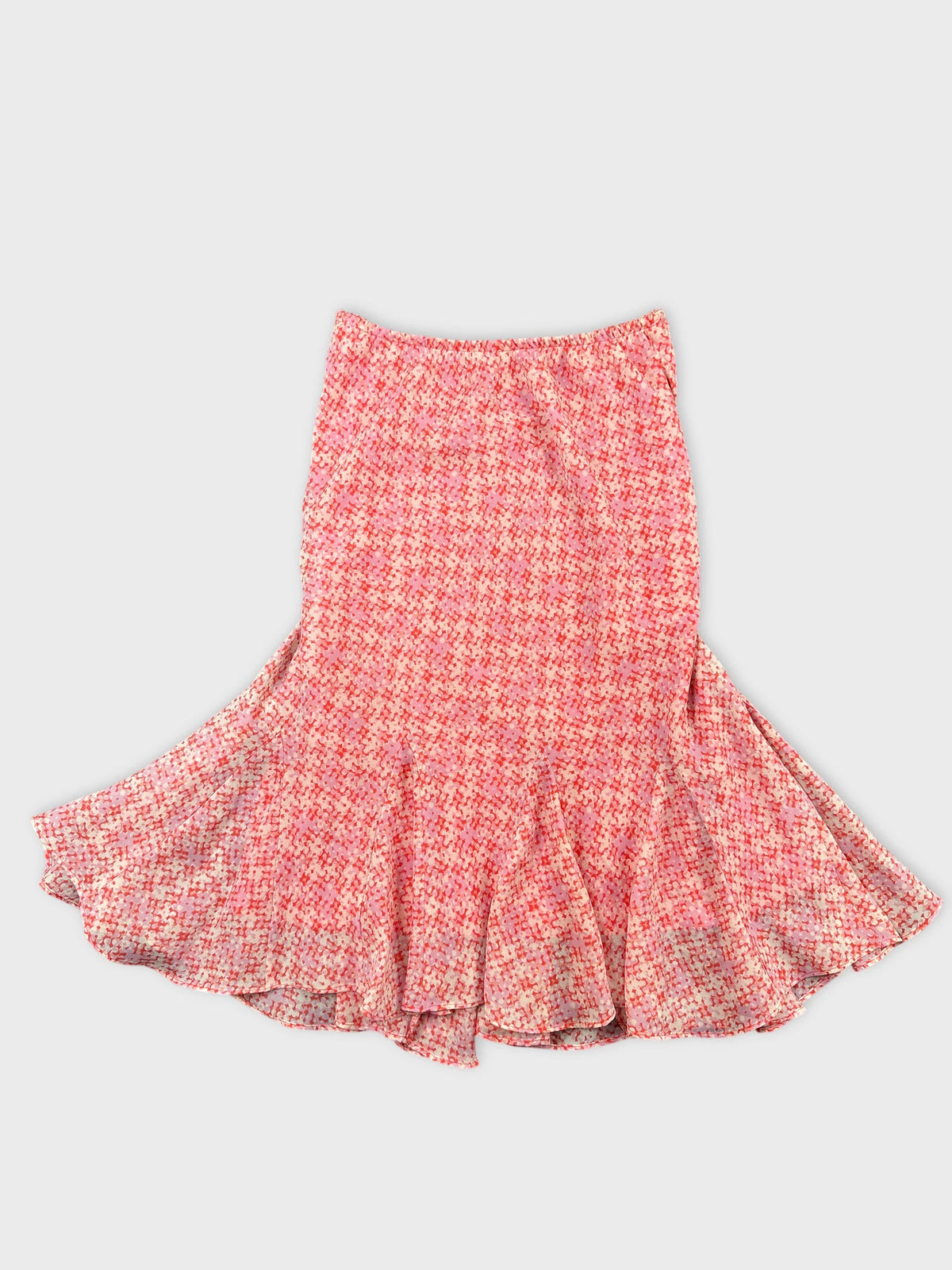 Front view of a flared pink skirt with a geometric print.